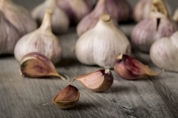 Close-up garlic bulbs and garlic cloves on wooden background