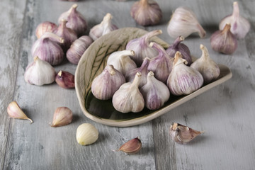 Close-up garlic bulbs and garlic cloves on wooden background