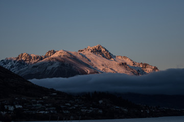 Sunrise over snowcaped mountain.