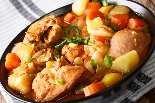 Spicy stewed chicken with vegetables close-up in a bowl. horizontal