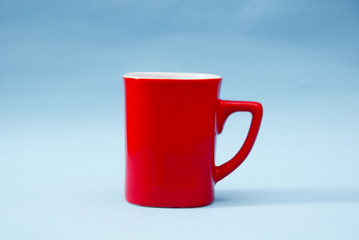 Red Mug Over Blue Background