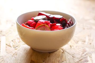 Beet salad vinaigrette in a wooden bowl