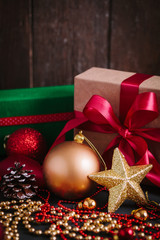 Composition with Christmas decorations  and gift on black background