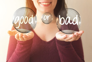 business woman holding transparent bubble with good or bad text