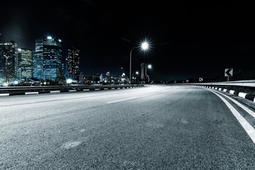 nigh scene of empty road in modern city