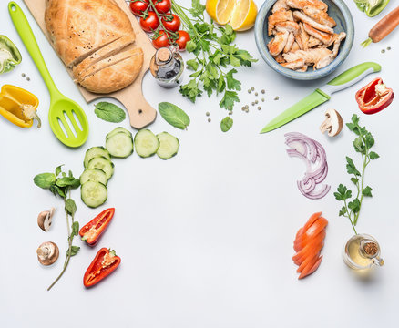 Healthy Clean Eating Layout For Lunch Food And Diet Nutrition Concept. Various Fresh Vegetables Ingredients For Salad With Green Cooking Spoon And Knife On White Table Background, Top View, Frame