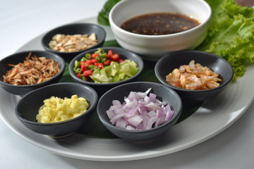 Thai Food wrapped in leaves include many Thai spices are shallots, ginger, chilli, coconut burns, lemon and Ayesha rocket leaves eat with chilli sauce tamarind together