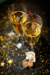 Two champagne glasses in golden glitter
