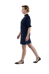 Female executive walking against white background