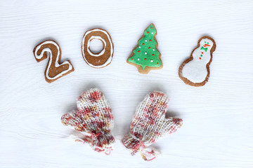 delicious and warming greetings/ festive ginger biscuits and pink knitted mittens top view