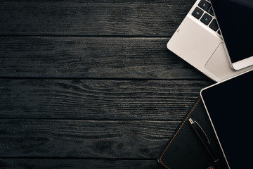 Work desk. Office, a laptop, a tablet, a notebook, a pen, a pencil, on a wooden background. Top...