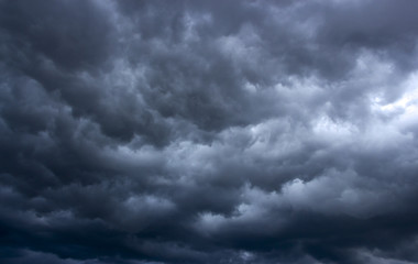 Obraz premium Heavy, stormy clouds of contrasting color over the evening city