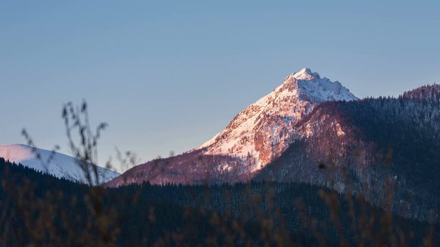Morning sunlight colors in mountain peak at sunrise. Time lapse dolly shot
