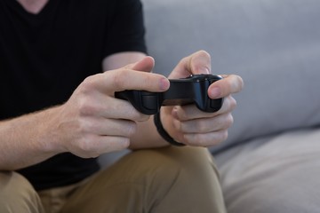Man playing video game against white background