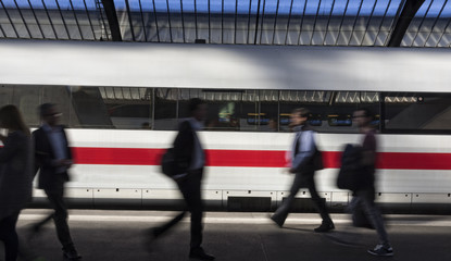 People on the move on a train station platform