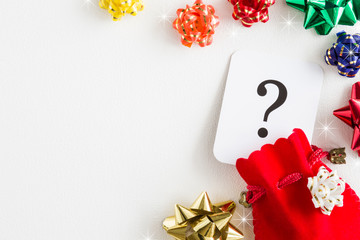 Red sack, question mark. Search and choose the best Christmas gifts for family, children, friends, colleagues and other people. Gifts waiting. Christmas time concept. Empty place for text. 