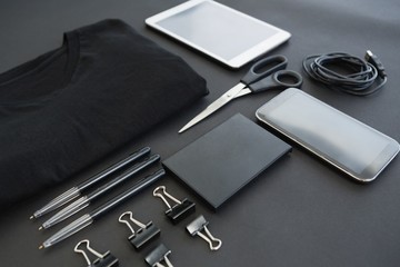 T-shirt, pen, wallet, scissors, usb cable, paper clip, mobile