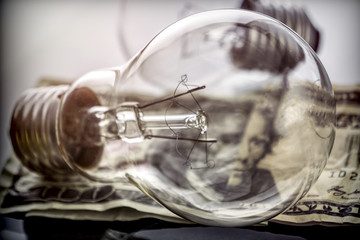 A lightbulb on dollar bill, energy saving concept