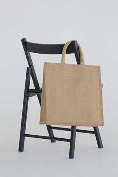 Grocery bag hanging on black chair