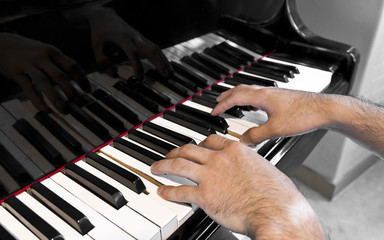 musician plays old grand piano