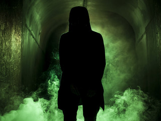 Silhouette of a man in fog green light