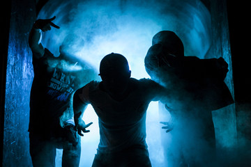Silhouette of three men in the blue light