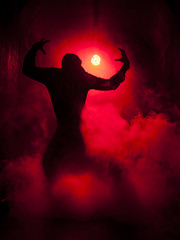 Silhouette of a dancer man in the red light