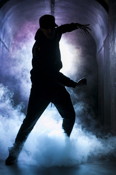 Silhouette of a dancer man in the blue light