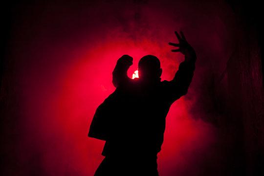 Silhouette of a dancer man in red light