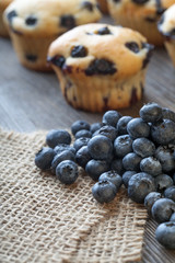 muffin with blueberries on a wooden table. fresh berries and sweet pastries on the board.