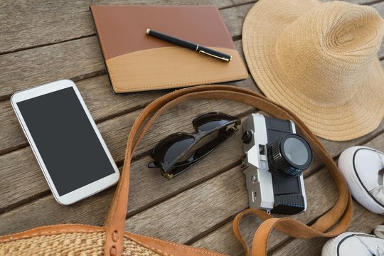 Travel accessories on wooden plank
