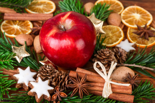 Christmas spices with Red Apple decorated over old wooden background