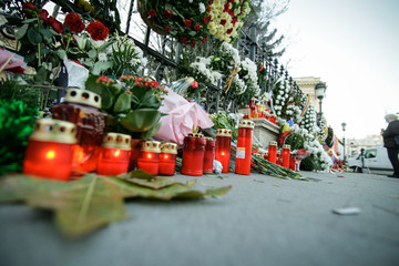Candles and flowers on the sidewalk