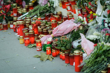 Candles and flowers on the sidewalk