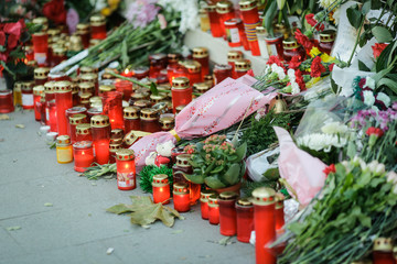 Candles and flowers on the sidewalk