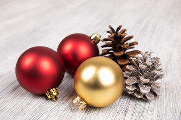 red and gold christmas balls on a wooden background