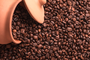 Clay pot and lid in coffee beans. Place for text or design.