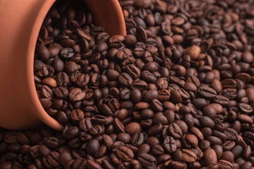 Fototapeta premium Clay pot in coffee beans. Place for text or design.