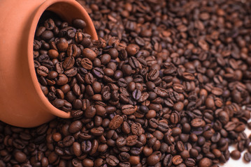 Coffee beans with clay pot background. Place for text or design.