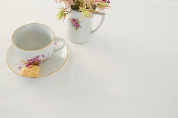 Empty cup and saucer with sweet food