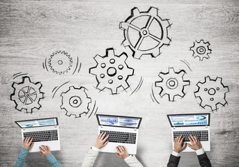 Top view of businesspeople sitting at table and using gadgets