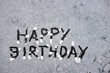 Happy birthday words written in snow 