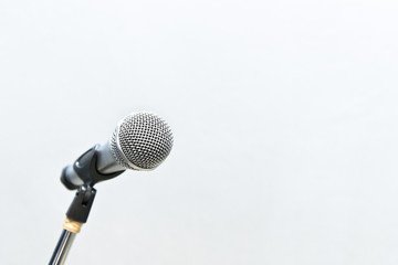 metallic microphone with grey cement wall