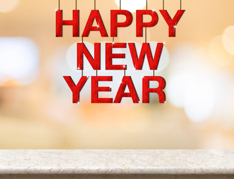 Happy new year red wood word hanging over marble table top with blurred bokeh light background,Holiday greeting card
