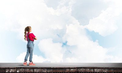 Concept of careless happy childhood with girl looking far away