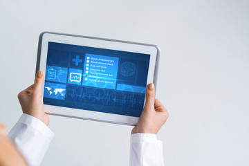 Close of female doctor hands working with tablet pc computer