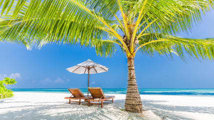 Fototapeta na wymiar Beautiful beach. Chairs on the sandy beach near the sea. Summer holiday and vacation concept. Inspirational tropical scene. Tranquil scenery, relaxing tropical landscape design