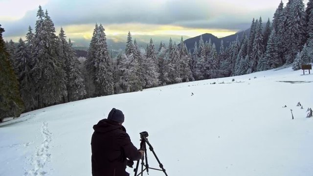 photographer photographing winter panorama
