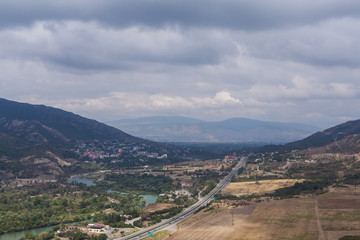 Fototapeta na wymiar Mountain town with road and lake