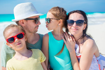 Closeup of family of four on beach